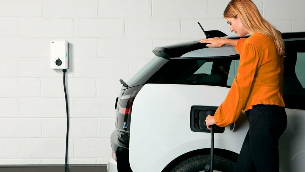 A-Woman-Charging-Her-Electric-Vehicle